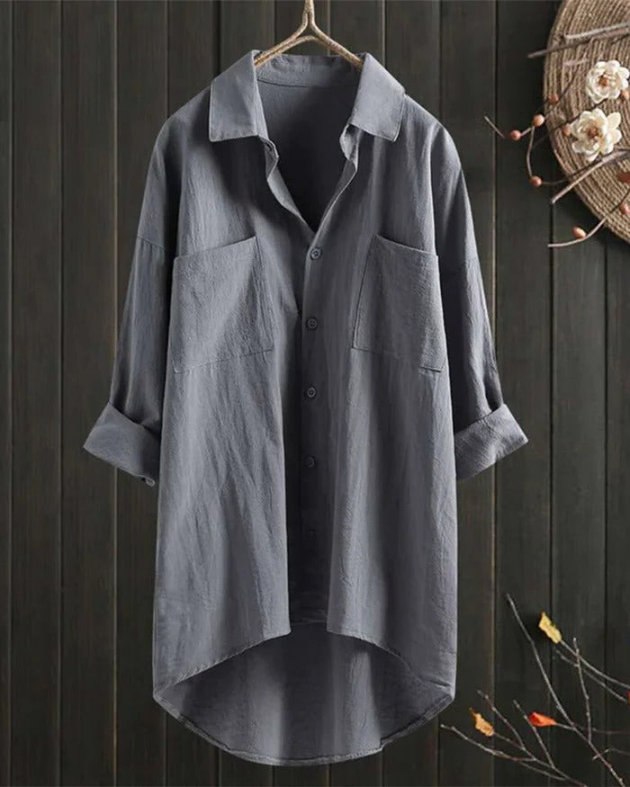 Women's white linen blouse by Belro, shown on a hanger with a relaxed fit and lightweight fabric, perfect for casual or summer wear.