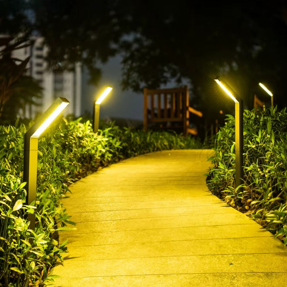 Belro solar pathway lights illuminating a garden walkway with warm LED light during evening outdoor setting.