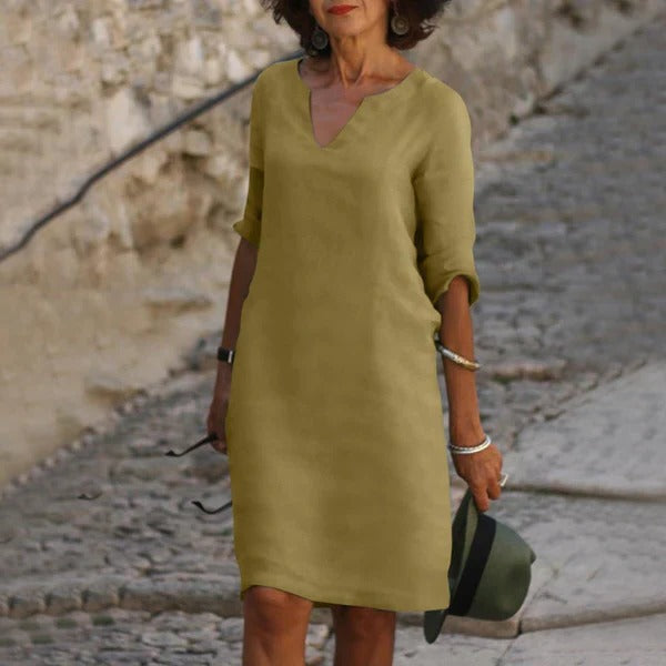 Belro V-neck three-quarter sleeve dress in soft fabric, showing a fitted silhouette and elegant neckline.