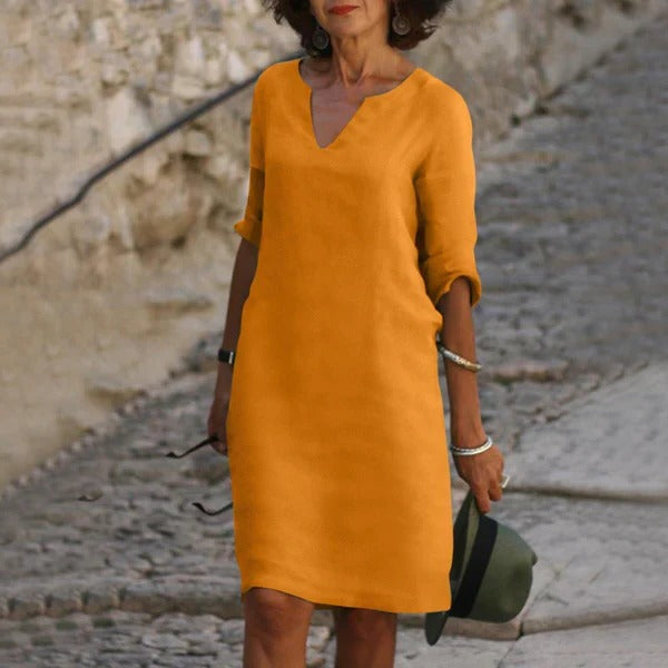 Belro V-neck three-quarter sleeve dress, stylish clothing with a fitted silhouette and elegant design, shown on a model.