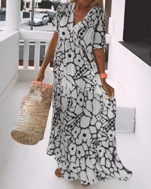 Belro long dress with short sleeves and printed pattern, flowing fabric, and elegant design perfect for casual or semi-formal wear.