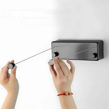 Belro space-saving retractable clothesline installed in a laundry room with clothes hanging for drying.
