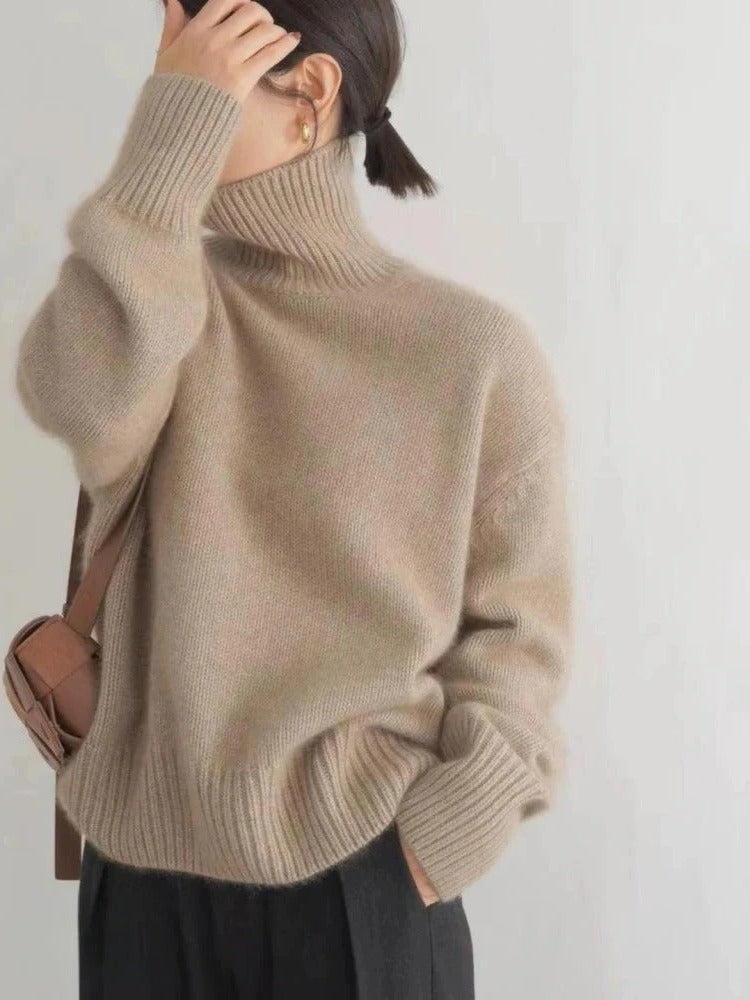 Belro merino wool turtleneck sweater in warm, cozy knit fabric, shown on a model with a high collar and long sleeves.