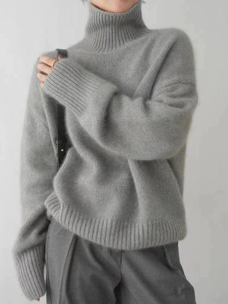 Belro merino wool turtleneck sweater in warm, cozy fabric, shown on a model with a high neck and ribbed cuffs.