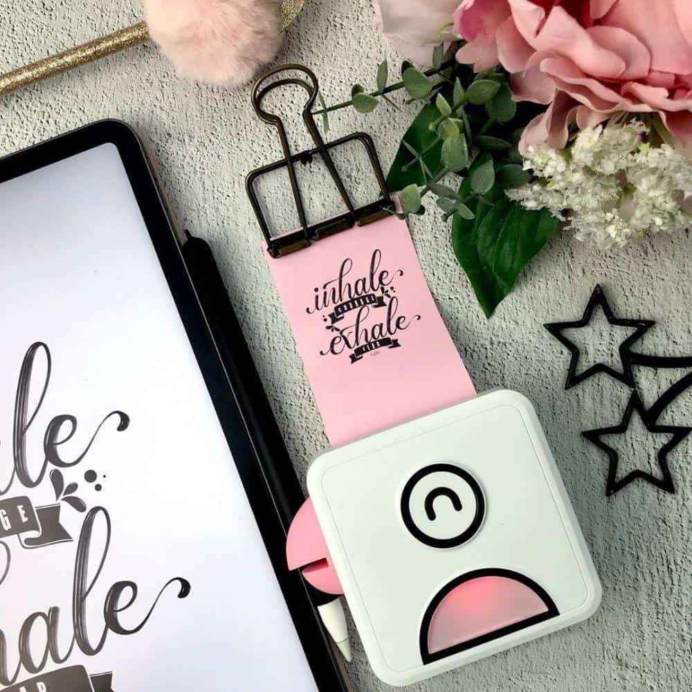 Belro Pocket Inkless Printer in use, compact electronic device with paperless printing technology, sleek design and portable form factor.