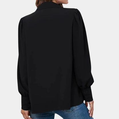 Belro pleated long sleeve women's blouse with a flowing design, featuring a classic neckline and elegant pleats.