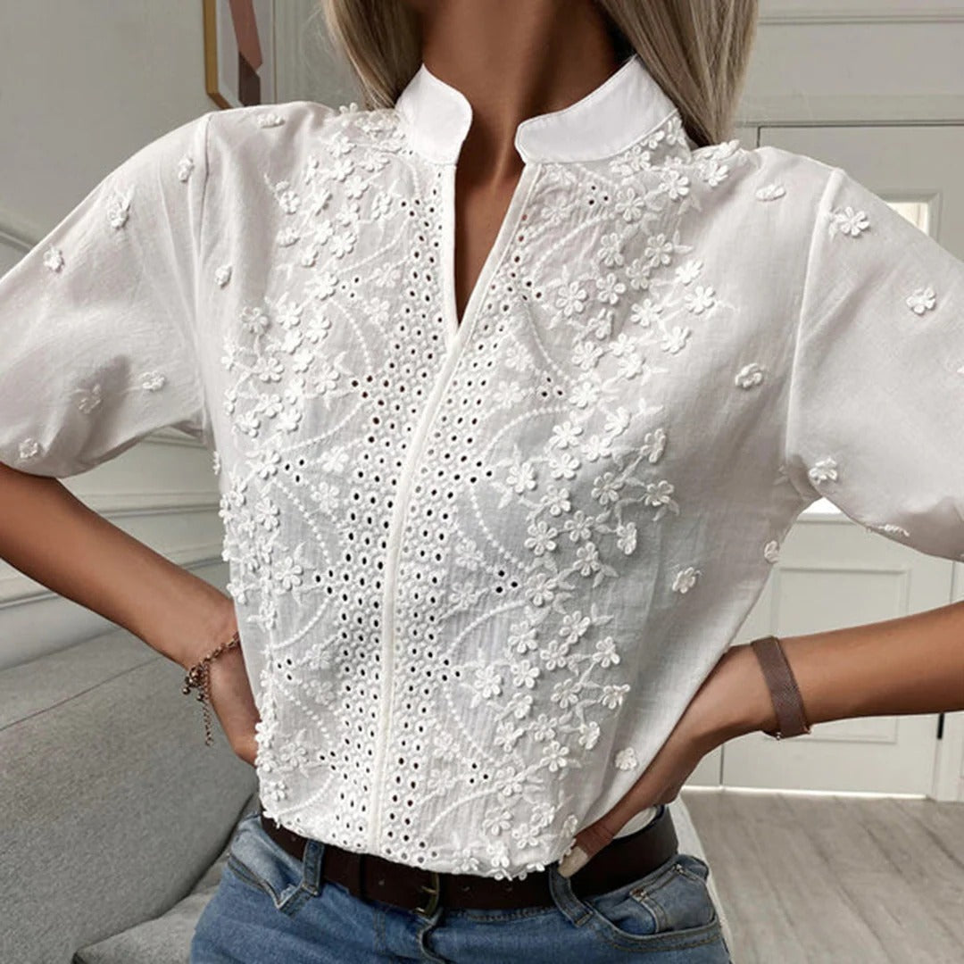 Belro fashionable blouse with long sleeves and button details, shown in a vibrant color on a hanger.