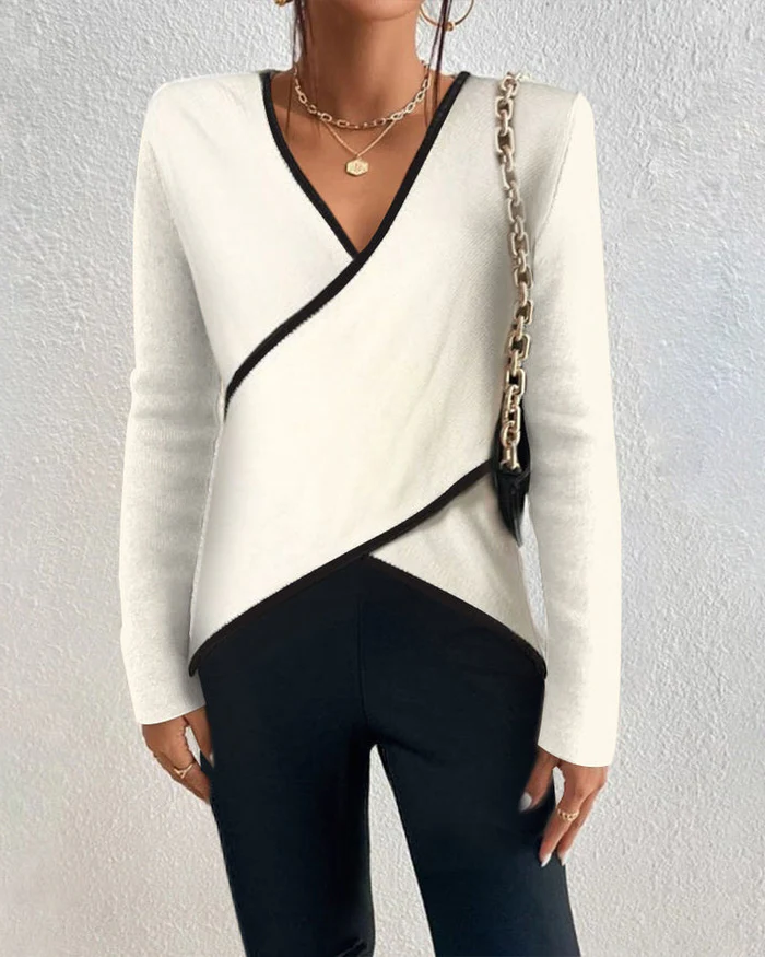 Ivory V-neck sweater by Belro, soft knit clothing item with long sleeves and a classic V-neck design.