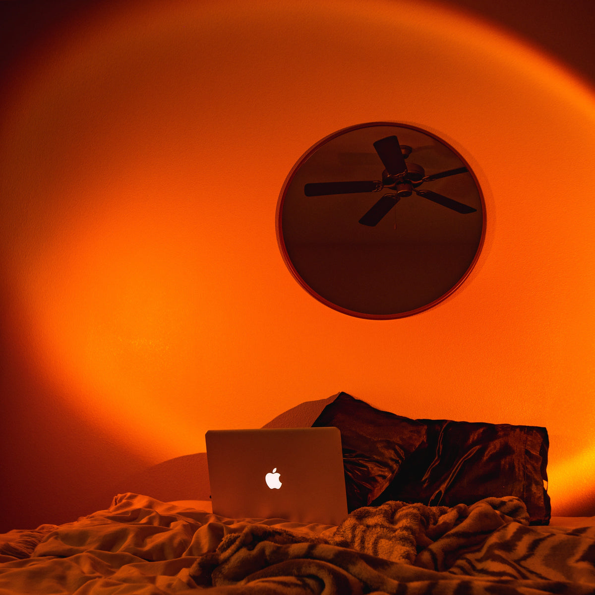 Belro Smart Sunset Lamp Deluxe emits warm, colorful lighting perfect for relaxing nighttime ambiance in a modern home.