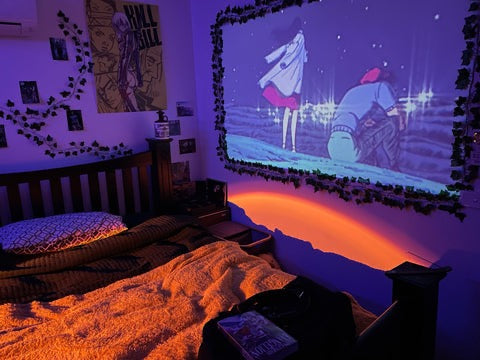 Belro Mini Movie Projector displaying a vibrant image on a wall, compact electronic device for home entertainment or presentations.