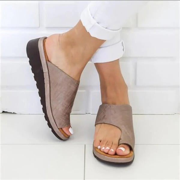 Belro corrective sandals designed for foot alignment relief, featuring cushioned straps and supportive sole in a neutral color.