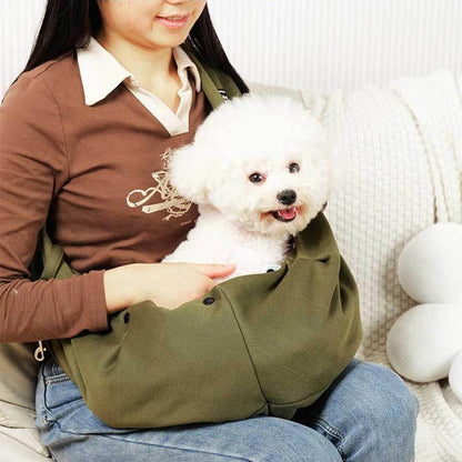 Belro dog carrier sling for automotive use, shown in a person wearing the soft, adjustable pet carrier for convenient travel.