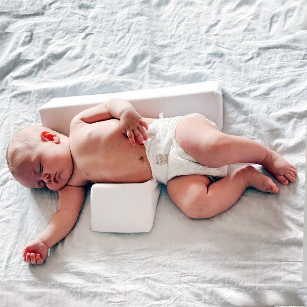 Belro newborn side sleeper wedge pillow designed for safe side sleeping and comfort in a home and garden bedding setting.