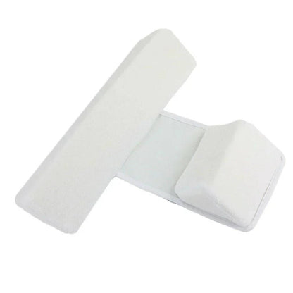 Belro newborn side sleeper wedge on bedding pillow, showing soft fabric and ergonomic shape for safe infant positioning
