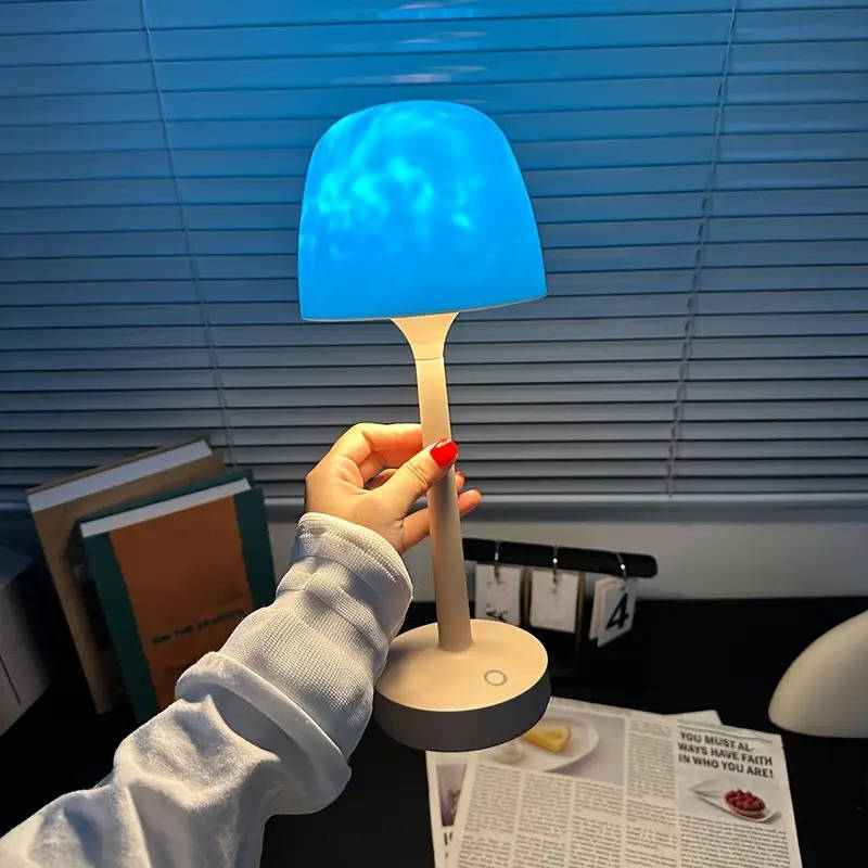 Belro cordless room light projector lamp displaying colorful star and moon projections on a wall in a cozy bedroom.