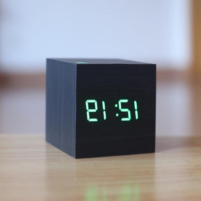 Black and green modern digital wood clock by Belro, placed on a desk in a stylish home office setting.