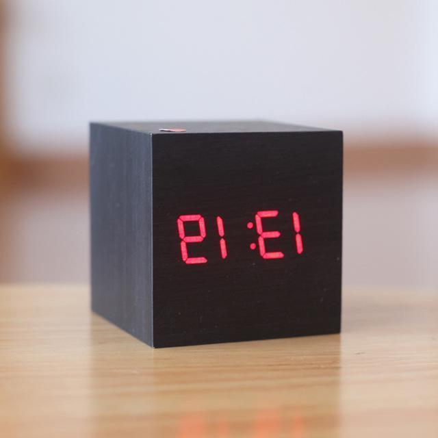 Black and red modern digital wood clock by Belro placed on a desk, showcasing a sleek design for home and office decor.
