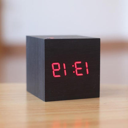 Black and red modern digital wood clock by Belro placed on a desk, showcasing a sleek design for home and office decor.
