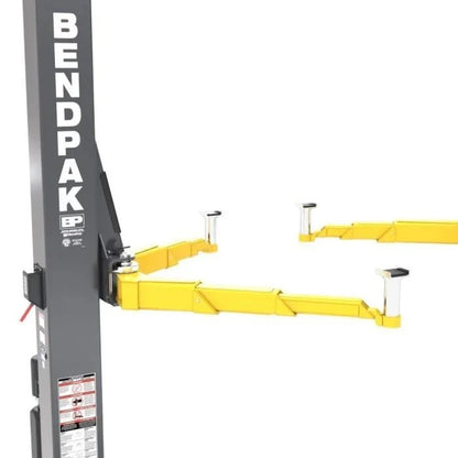 Casavibeo BendPak 12APX-192 12,000 lb clearfloor two-post lift shown in a garage setting with sturdy metal arms and safety features.