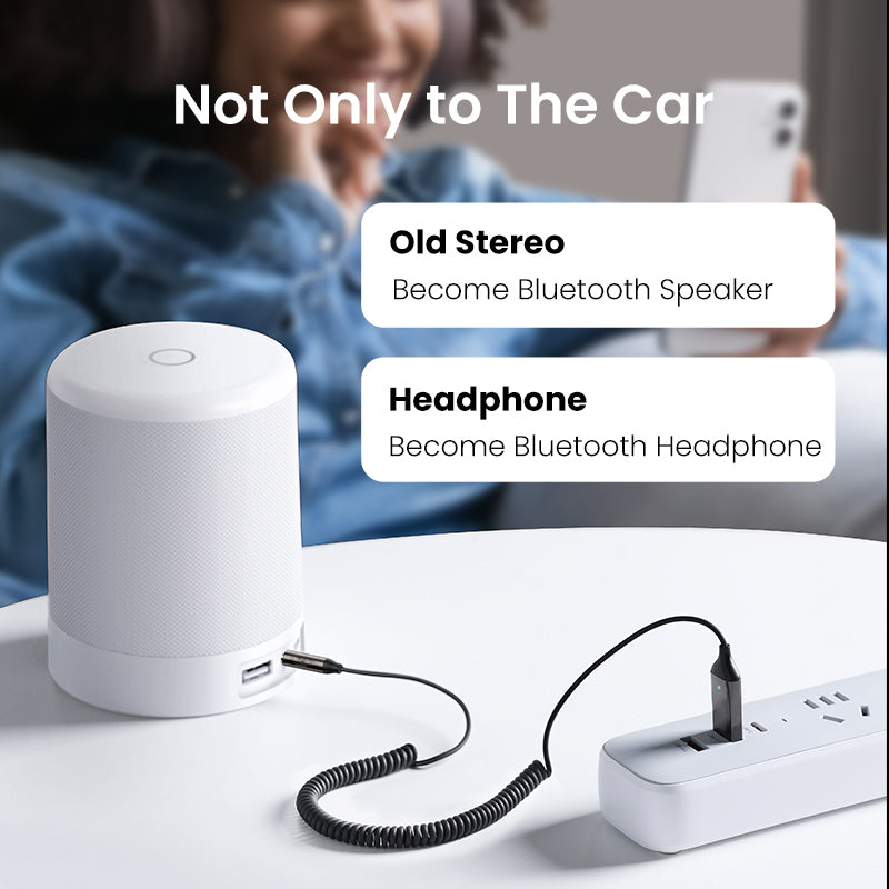 Belro Bluetooth Aux Adapter connected to audio device, compact electronic accessory for wireless audio streaming.