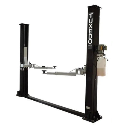 Casavibeo TP9KF TUX 9,000lb 2 Post Symmetric Car Lift showing the lift structure and platform in a workshop setting.