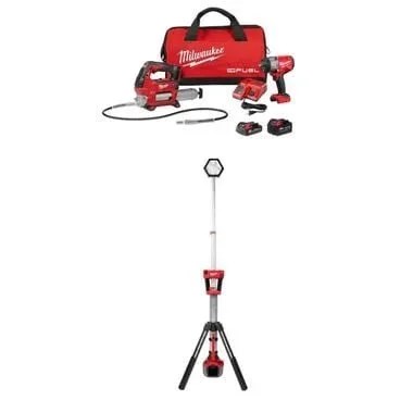 Milwaukee M18 FUEL 1/2 inch HTIW combo kit with dual power tower light and tools, displayed with accessories on a workbench.