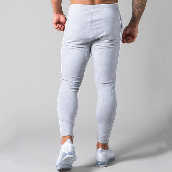 Slim-fit banded joggers by Belro, shown in a neutral color, featuring an elastic waistband and tapered legs for a stylish, comfortable fit.