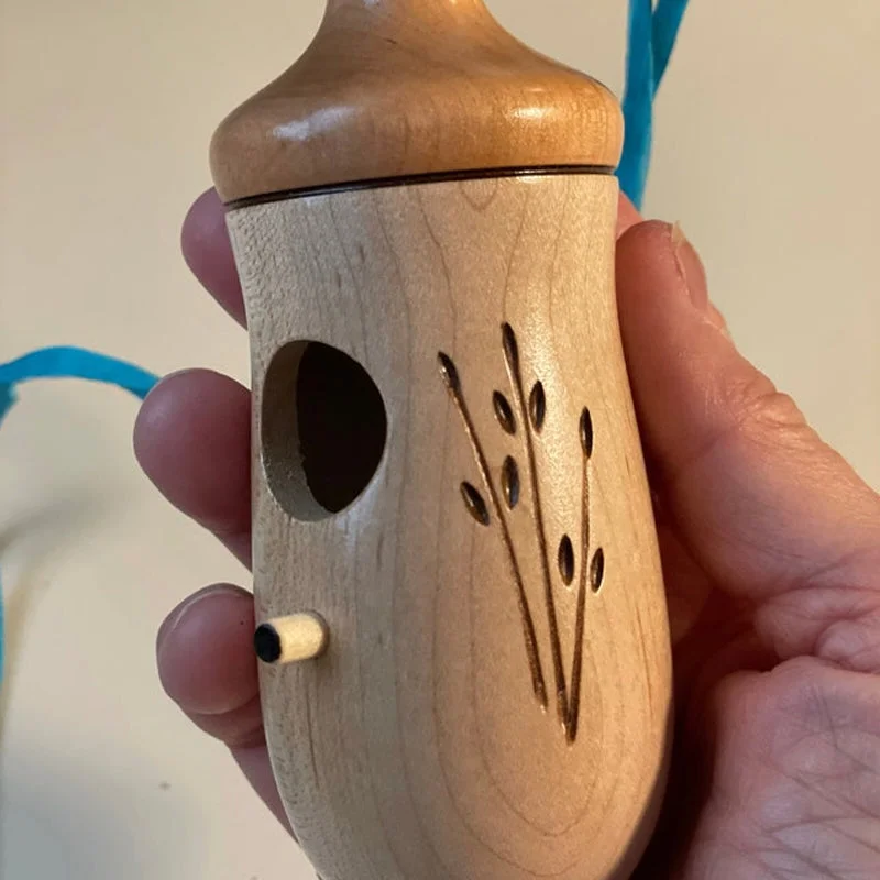 Wooden hummingbird house by Belro, natural wood finish, decorative bird house suitable for garden or outdoor decor.