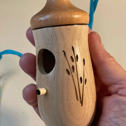 Wooden hummingbird house by Belro, natural wood finish, decorative bird house suitable for garden or outdoor decor.