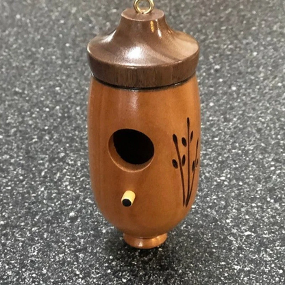 Wooden hummingbird house by Belro, decorative garden decor for nature lovers, showcasing a handcrafted wooden bird shelter.