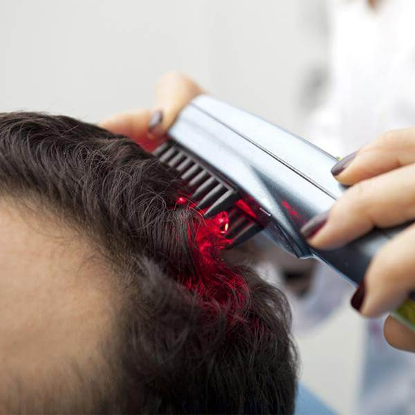 Belro professional hair regrowth laser comb for men, showing the sleek black device with laser treatment slots.