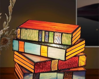 Belro Books Lamp for office and stationery, featuring a sleek design with a built-in light and a stack of colorful books.