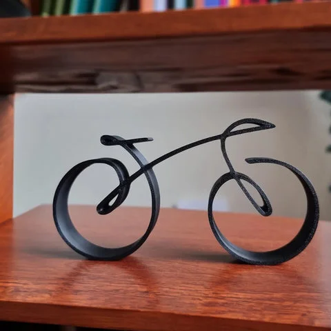 Wire framed minimalist bicycle sculpture by Belro, perfect for outdoor home and garden decor, featuring a sleek and modern design.