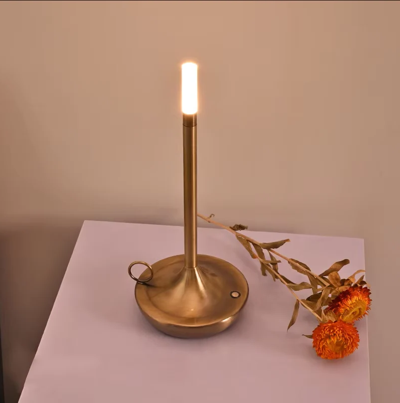 Belro rechargeable touch table lamp with a sleek modern design, illuminated in a soft warm light on a wooden surface.