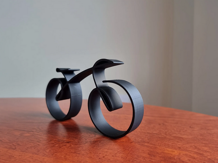 Wire framed minimalistic bicycle sculpture by Belro, outdoor metal art piece for home and garden decor.