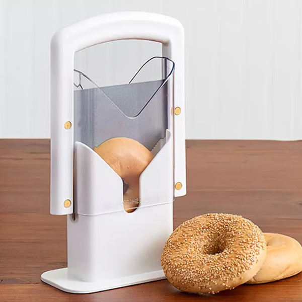 Belro stainless steel bagel slicer for small and large bagels, shown on a kitchen countertop with a sliced bagel.