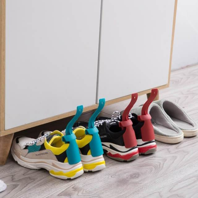 Belro Clip-N-Slip Easy Lazy Shoe Horn attached to a dress, showcasing its convenient design for easy shoe removal and dressing assistance.