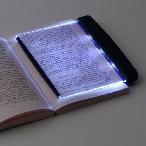 Belro Bright Eyes Book LED light attached to a book, providing focused illumination for reading and office use.