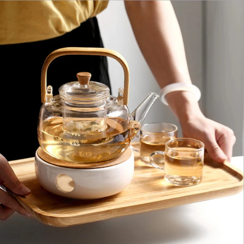 Clear borosilicate glass teapot with a stainless steel infuser, heat-resistant and suitable for boiling tea.