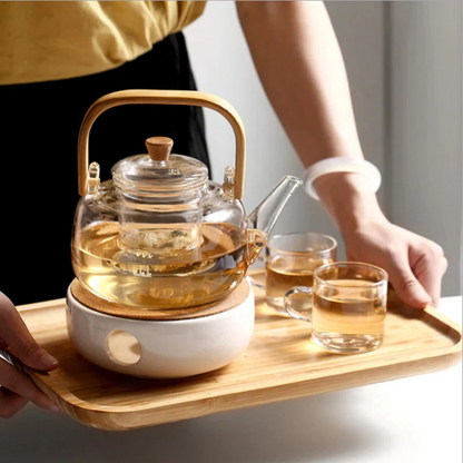 Clear borosilicate glass teapot with a stainless steel infuser, heat-resistant and suitable for boiling tea.