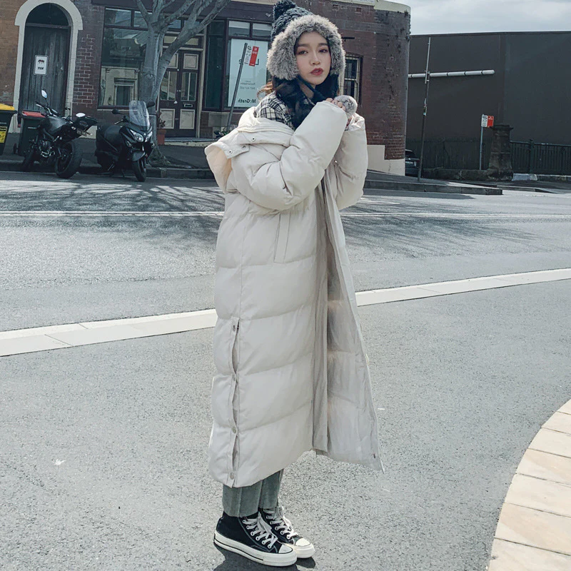 Belro long quilted winter coat with warm insulation and elegant design, shown hanging on a wooden hanger.