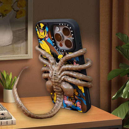 Belro Horrible Facehugger phone holder mounted on a smartphone, showcasing its unique design and secure grip for electronics accessories.