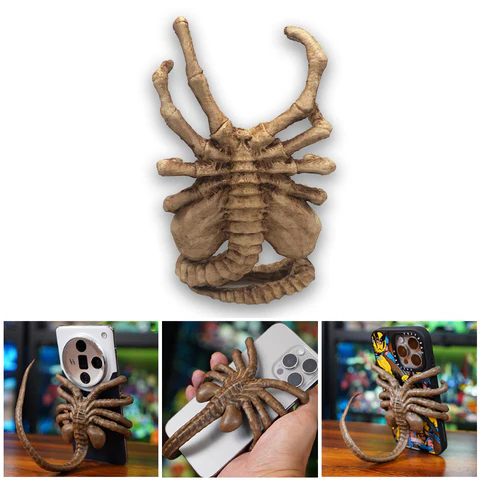 Belro Facehugger phone holder attached to a smartphone, featuring a creepy alien facehugger design for electronics and phone accessories.
