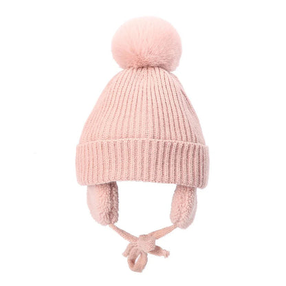 Pink kids knit beanie winter hat with earflaps from Belro, featuring cozy yarn and playful design for cold weather warmth.