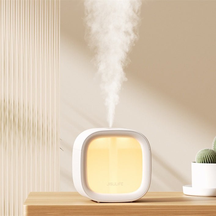 White cube-shaped Casavibeo bedroom humidifier with a water tank and control buttons, designed for quiet USB operation.