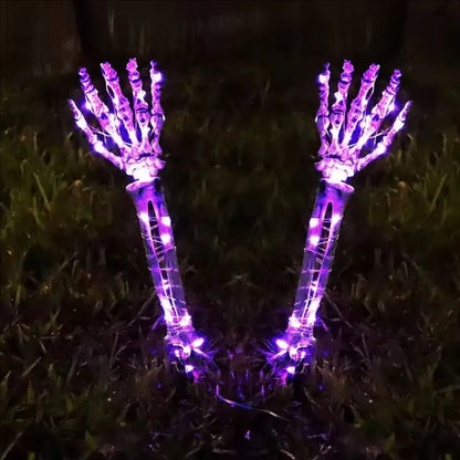 Purple Halloween skeleton hand solar light attached to umbrella, decorative accessory by Belro for spooky outdoor Halloween decor.