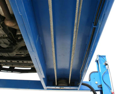 Atlas 412 12,000 lbs Casavibeo commercial 4-post lift with sturdy steel columns and safety arms for vehicle lifting.