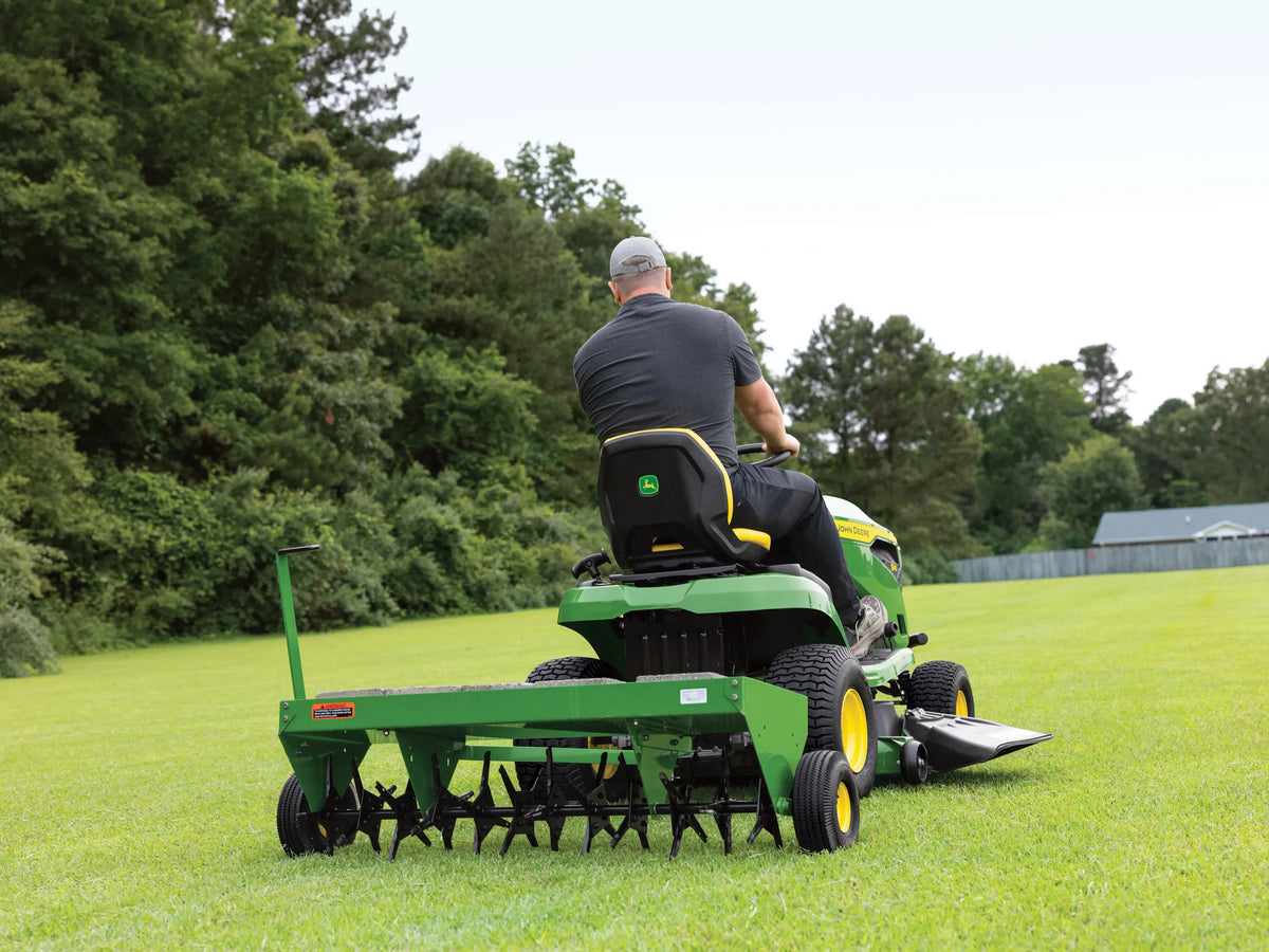 John Deere S140 riding lawn tractor with 48-inch deck, 22 HP V-twin engine, hydrostatic transmission, shown in a grassy yard.