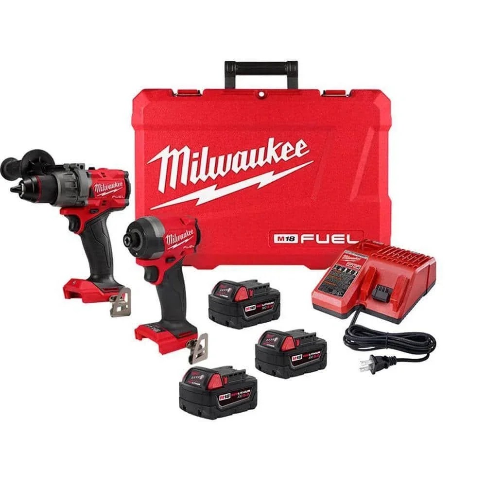 Milwaukee M18 FUEL 18V lithium-ion cordless hammer drill and impact driver set with black and yellow tools on a workbench.