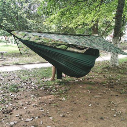 Belro outdoor two-person camping hammock with canopy, set up outdoors in a garden, ideal for relaxing and camping trips